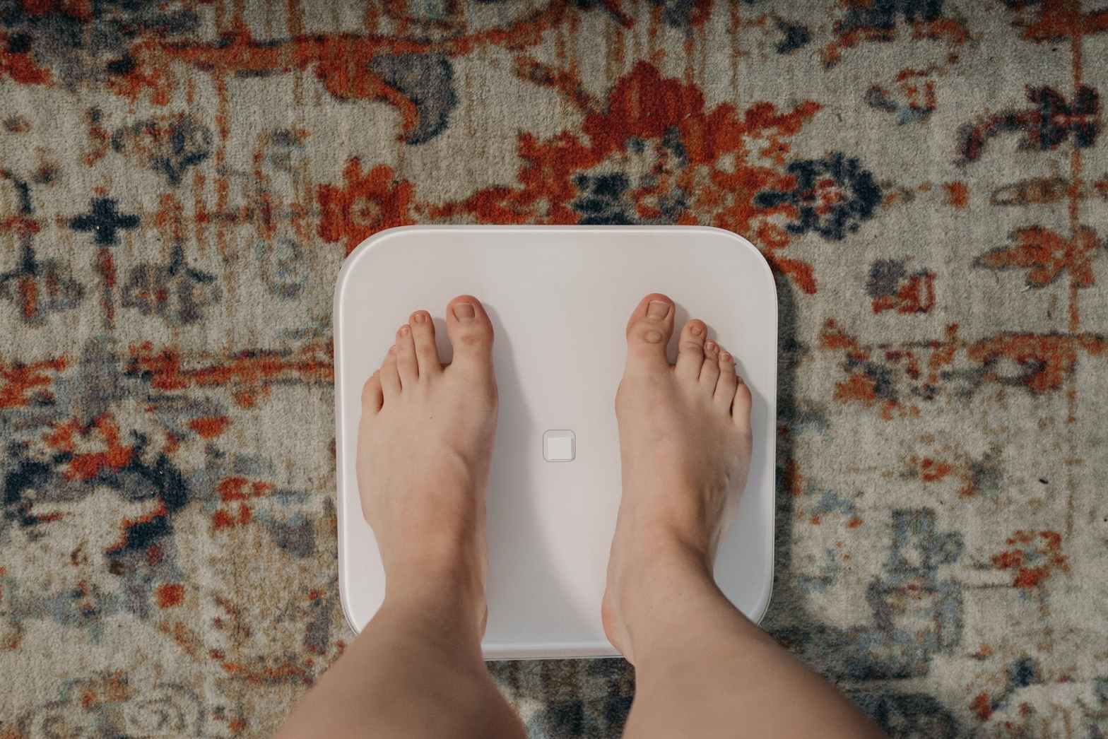person standing on white weighing scale